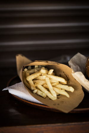 Delicious hamburger with french fries on wooden tableの写真素材