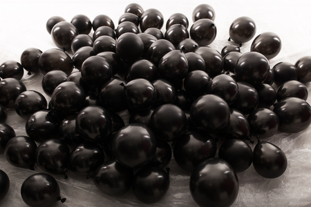 Black inflatable balls for the holiday. In studio on a white background.の写真素材