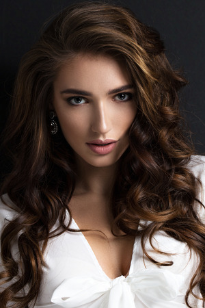 Beauty portrait of a beautiful woman. Dark backgroundの写真素材