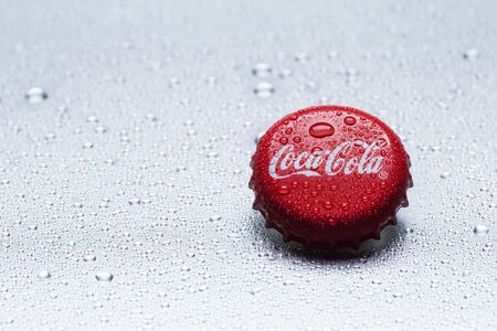Kiev, UKRAINE - January 12, 2017: classic cap close-up of Coca-Cola on a gray background with drops of water.のeditorial素材