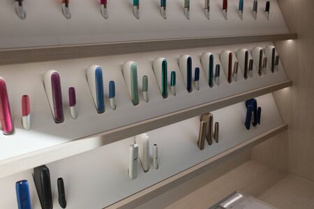 Kiev, Ukraine - January 17, 2019: New design IQOS. Showcase with a large multi-colored selection.のeditorial素材