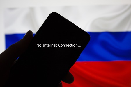 Smartphone in hand without internet connection on the background of the Russian flagの写真素材