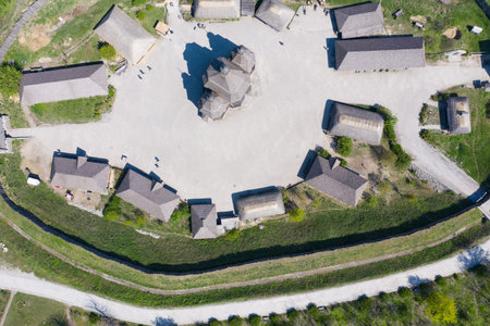 Aerial shot of an old village with wooden houses and a church. Tourist place.