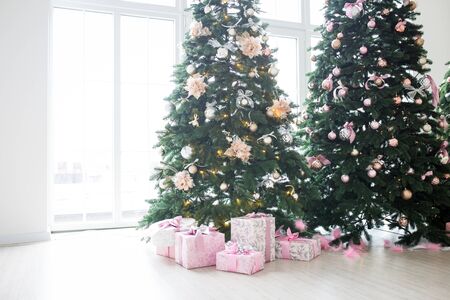Two elegant Christmas trees in a bright room. New Years and Christmasの写真素材