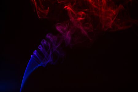 Colorful smoke close-up on a black backgroundの写真素材