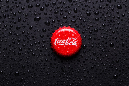 Kiev, UKRAINE - January 28, 2019: classic cap close-up of Coca-cola. Cap of cola on a black...