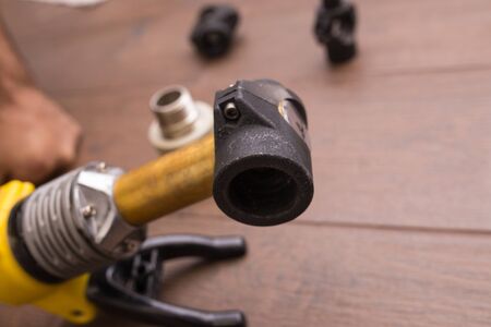 Soldering iron for a plastic water pipe close-up. The device stands heats the temperature.の写真素材