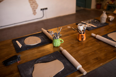 A master class in modeling a clay jug. Table with clay and a tool for creativity.