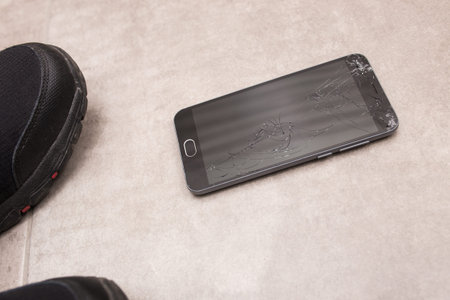 The black smartphone fell out of my hands and the screen crashed to smithereens.