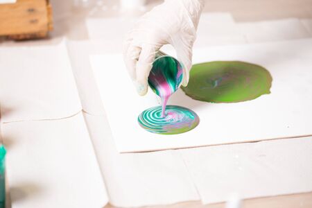 The girl creates a picture with abstraction in bright colors.の写真素材