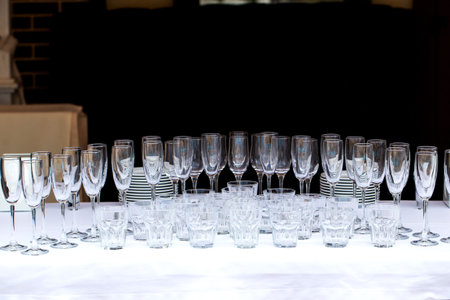 Glasses of champagne at a party or wedding celebration. The waiter pours champagne close-up.