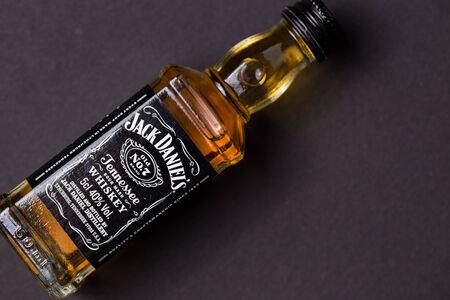 Kiev, Ukraine - June 12, 2019: Jack Daniels whiskey bottle. 50 ml souvenir bottle on a black background.のeditorial素材