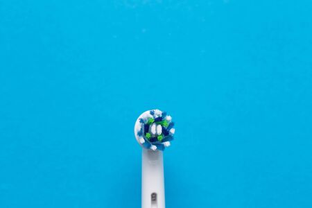 Smart electric toothbrush on a blue background close-up. Nozzle for brushing teeth.の写真素材