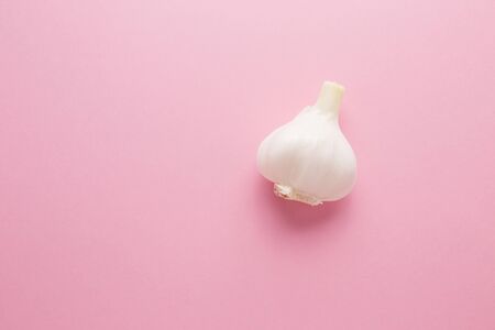 Garlic on a pink background close-up. Prevention of virus diseases.の写真素材