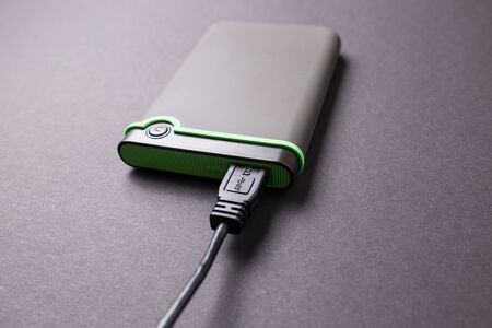 Hard disk on a black isolated background close-up.の写真素材