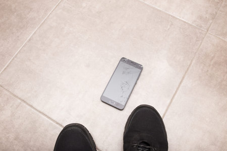 The black smartphone fell out of my hands and the screen crashed to smithereens.