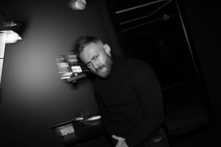 Portrait of a brutal man in a barbershop. Black and white photo of a bearded man.の写真素材