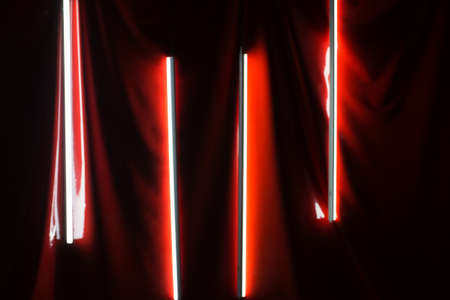Blurred photo. White neon lamps on a red background.の写真素材