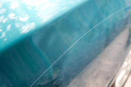 Scratch on a car body close-up. Damage to the paintwork.