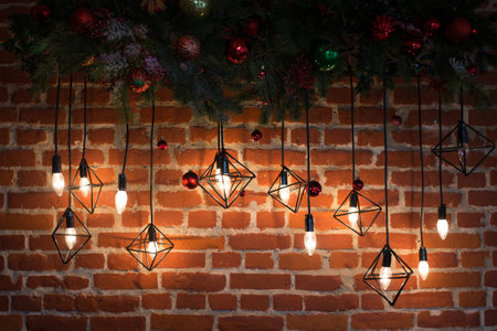 Brick wall with light bulbs and New Years decoration