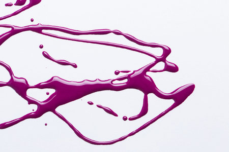 Nail polish on a white background in the form of strips and drops