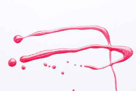 Nail polish on a white background in the form of strips and dropsの写真素材