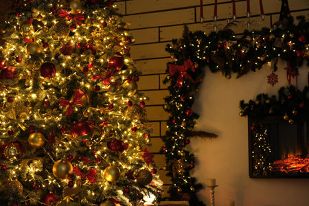 New Year tree with Christmas decorations lights and fireplace.の写真素材