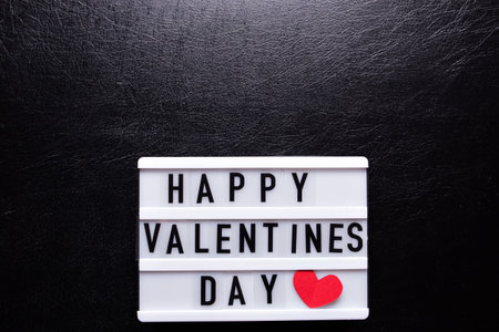 Box with the inscription Happy Valentines Day on a black background.