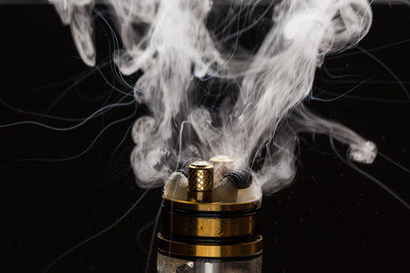 Vape close-up with smoke on a black backgroundの写真素材