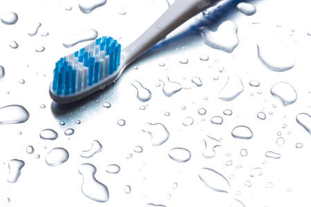 Blue toothbrush on a gray background closeupの写真素材