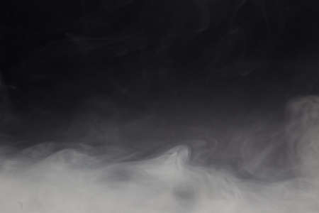Cloud of white smoke on a black background closeupの写真素材