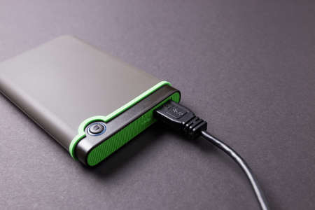 Hard disk on a black isolated background close-up.の写真素材