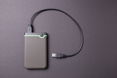 Hard disk on a black isolated background close-up.の写真素材