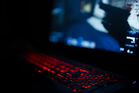 Kiev, Ukraine - June 12, 2019: Red backlit keyboard close up. Gaming laptop.のeditorial素材
