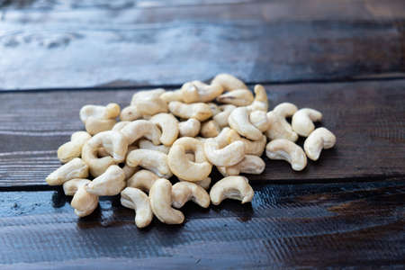 Raw cashew nuts on a wooden table close-upの写真素材