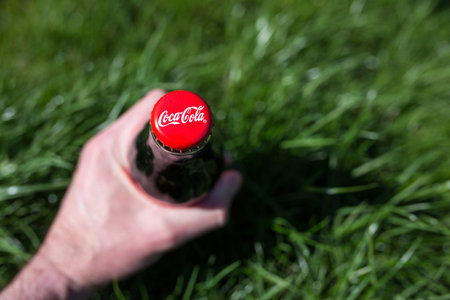 KYIV, Ukraine - April 22, 2018: Soka -Cola - one of the favorite drinks in the world. The bottle lies in the green grass.のeditorial素材