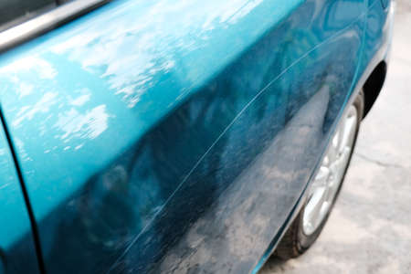 Scratch on a car body close-up. Damage to the paintwork.の写真素材