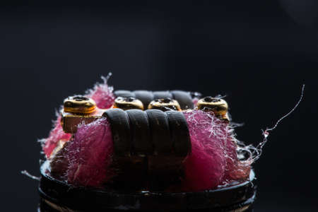 Vape close-up with wet cotton wool on black backgroundの写真素材