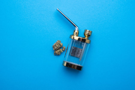 Hookah with marijuana on a blue background close-up.