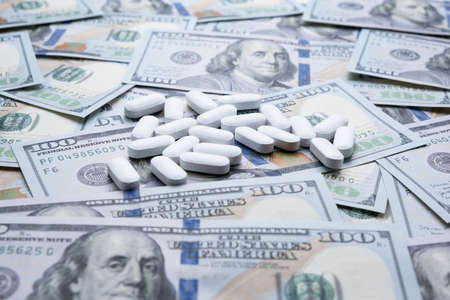 Pills on the background of the dollar close-up.の写真素材