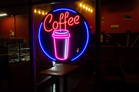 Coffee inscription glows neon sign close-up.の写真素材