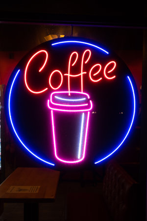 Coffee inscription glows neon sign close-up.の写真素材