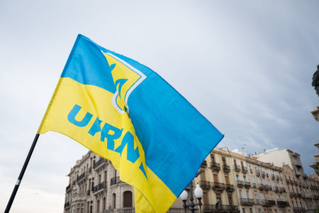 Flag of Ukraine on the background of a building in Spain.