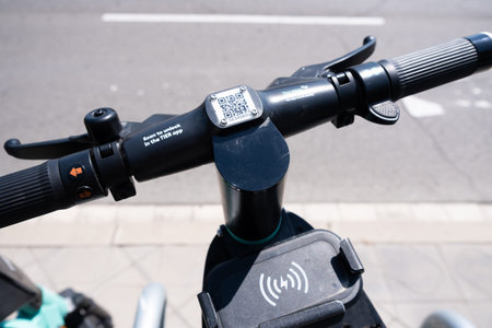 Tarragona, Spain - June 12, 2022: Steering wheel with a qr code for renting an electric scooter close-up.のeditorial素材