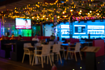 Blurred photo of a cafe with night lights.の写真素材
