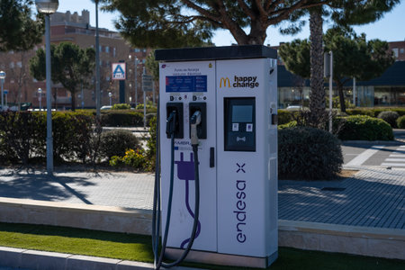 Tarragona, Spain - February 02 2023: Charging station for electric cars in the parking lot of McDonalds.のeditorial素材
