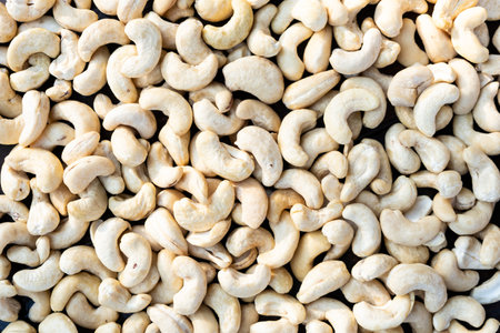 Raw cashew nuts on a wooden table close-upの写真素材