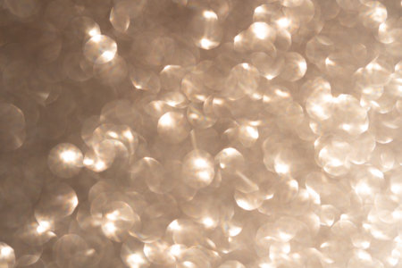 Blurred photo glitter texture on black background.の写真素材