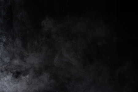 Cloud of white smoke on a black background closeupの写真素材