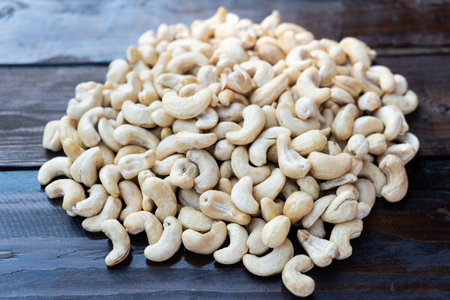 Raw cashew nuts on a wooden table close-upの写真素材